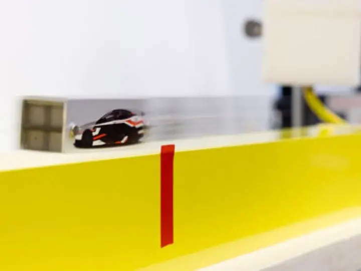Levitated-Model-Car-Zooming-Over-Superconducting-Guideway.webp