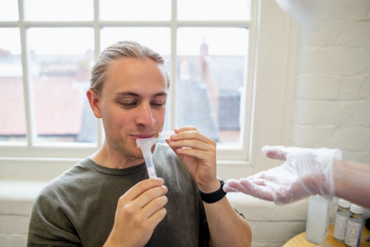 Man-giving-saliva-sample.webp