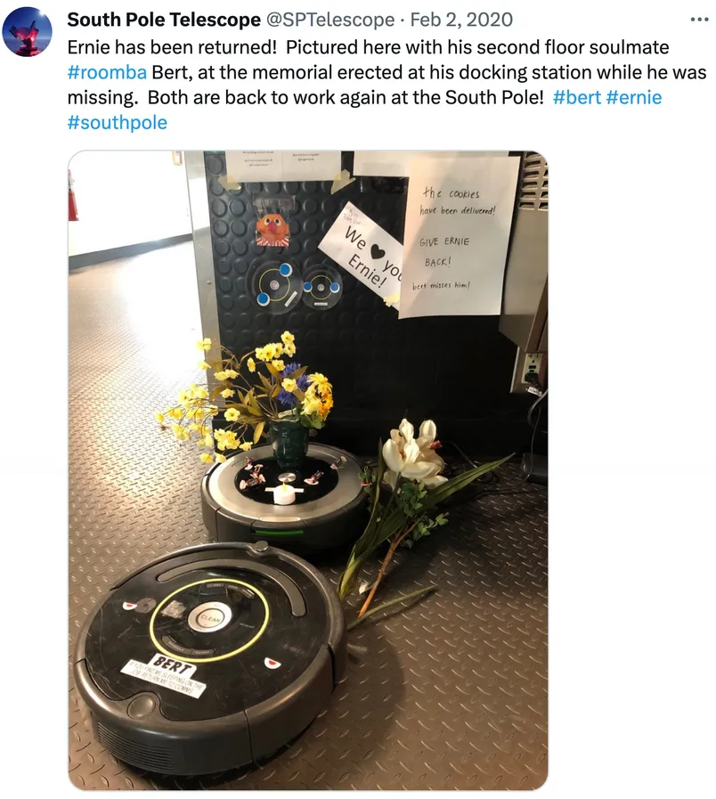 a-twitter-post-shows-two-roombas-flowers-and-signs.webp
