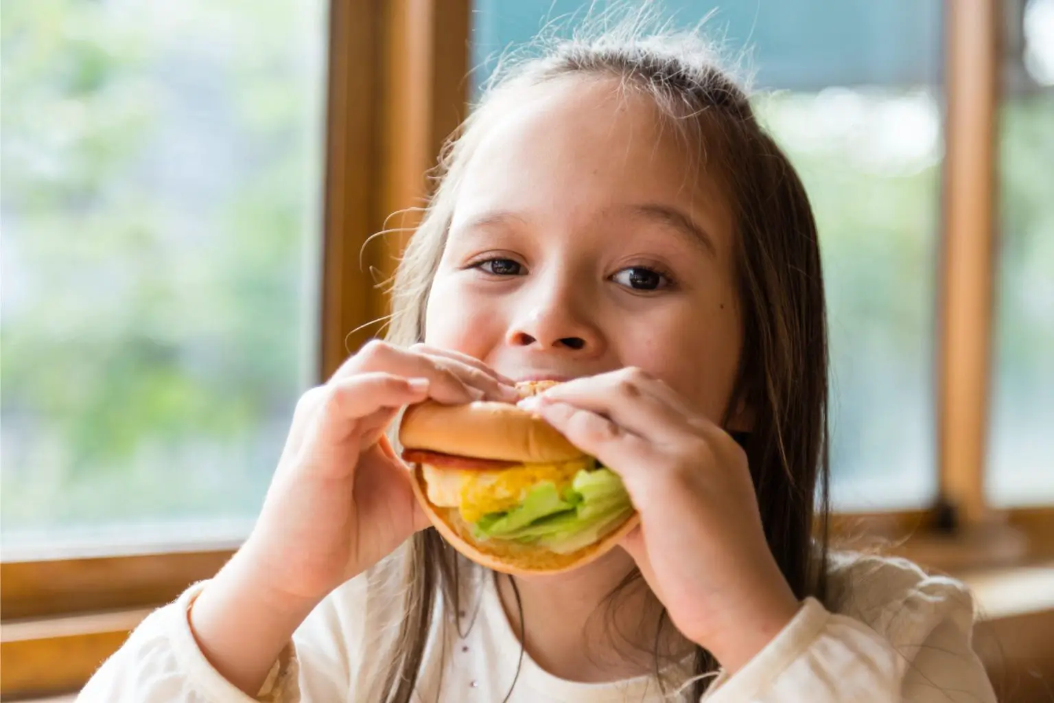 Young-Girl-Eating-Hamburger-1536x1024.webp