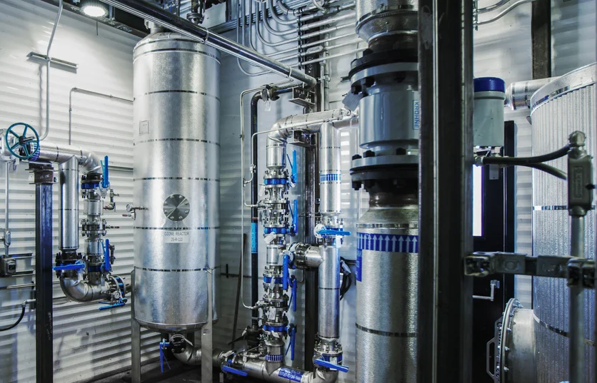 large-silver-canisters-of-equipment-with-pipes-connecting-them.webp