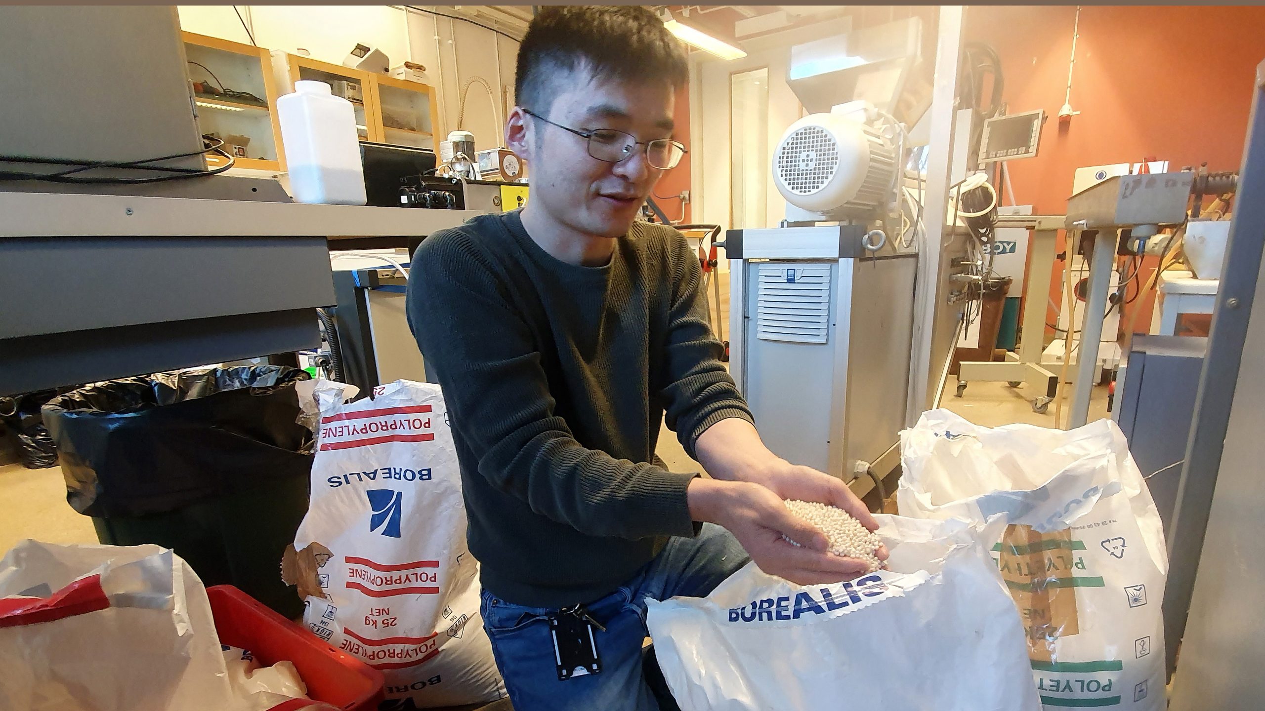 Xinfeng-Wei-Unpacking-Plastic-Pellets-scaled.jpg