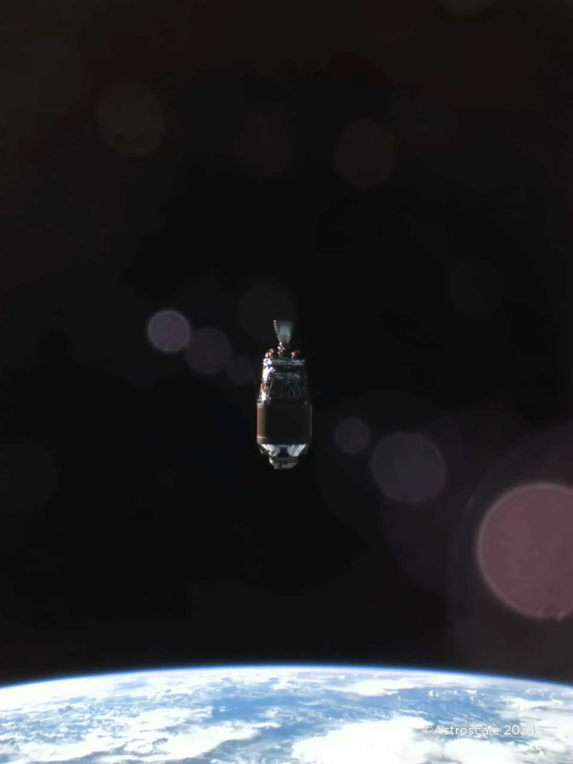 Space_Debris_Above_Earth_Taken_During_Fly_Around_Observation_by_Astroscales_ADRAS_J.webp