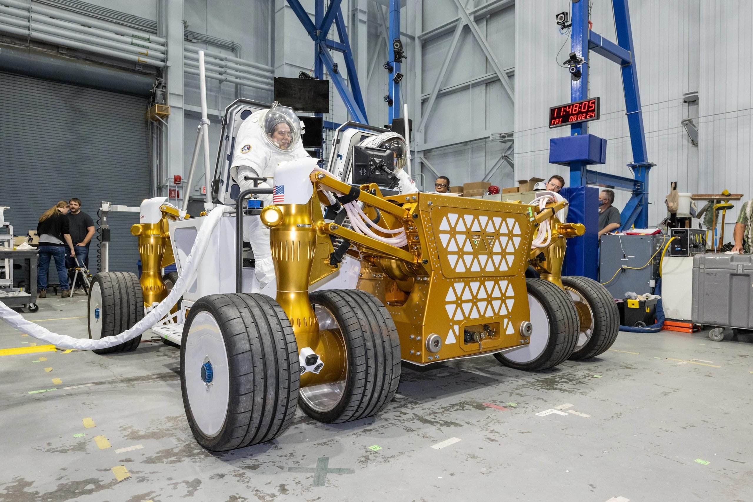 Suited-NASA-Engineers-Sit-on-Rover-Prototype-scaled.jpg