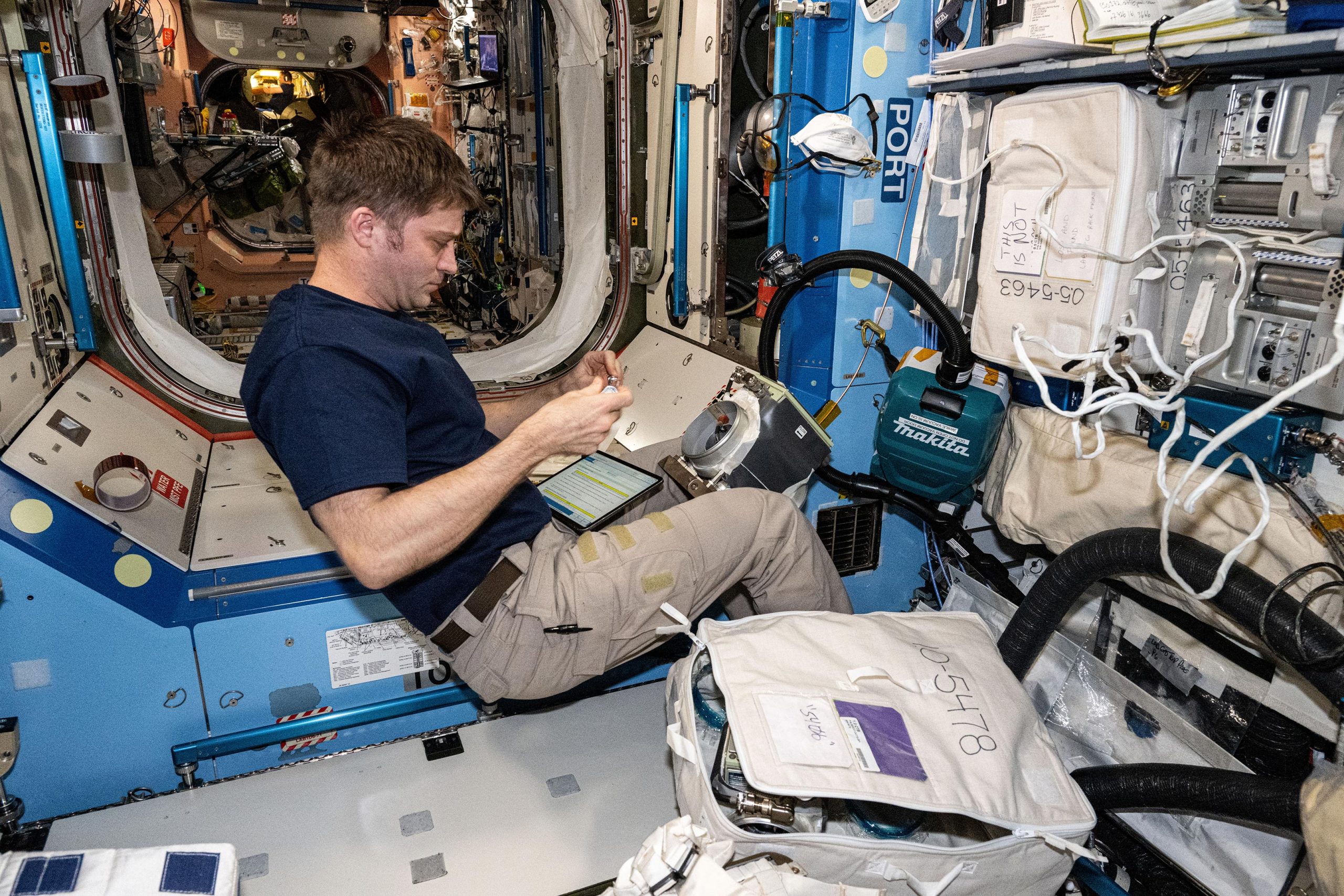 Astronaut-Matthew-Dominick-Works-on-Ventilation-Maintenance-scaled.jpg