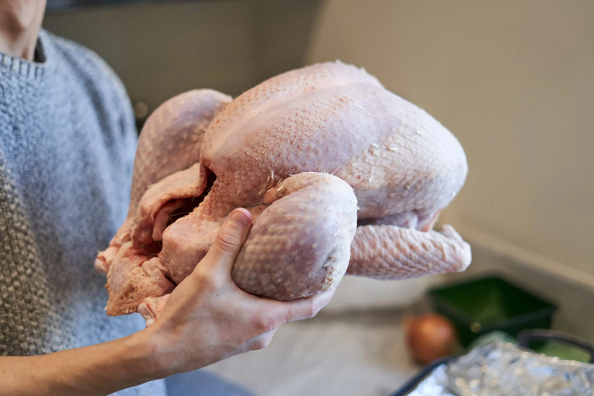 Holding-Raw-Turkey.webp
